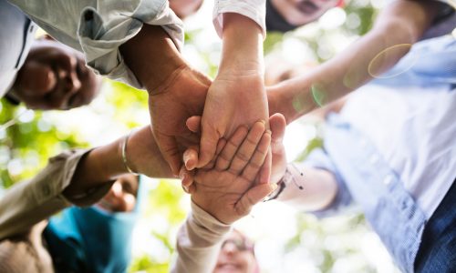 Group of diverse youth hands joined